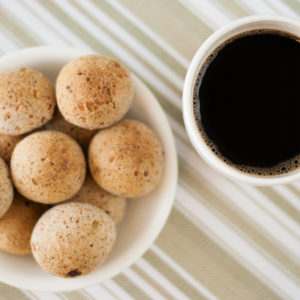 Brazilian cheese bread in a bowl with cup of black coffee