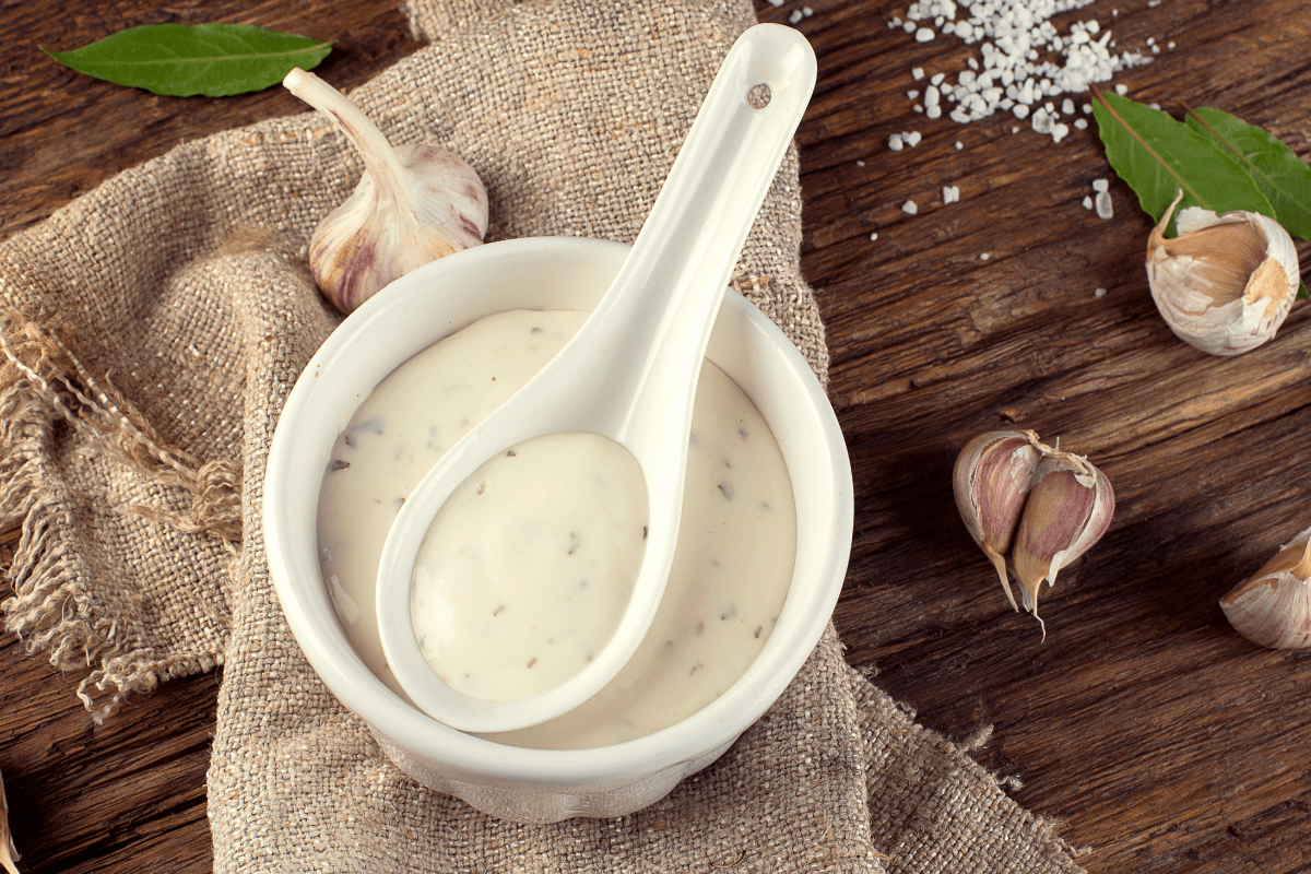 creamy white sauce in white bowl with spoon