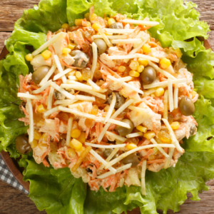 Brazilian-style chicken salad over lettuce and topped with potato sticks