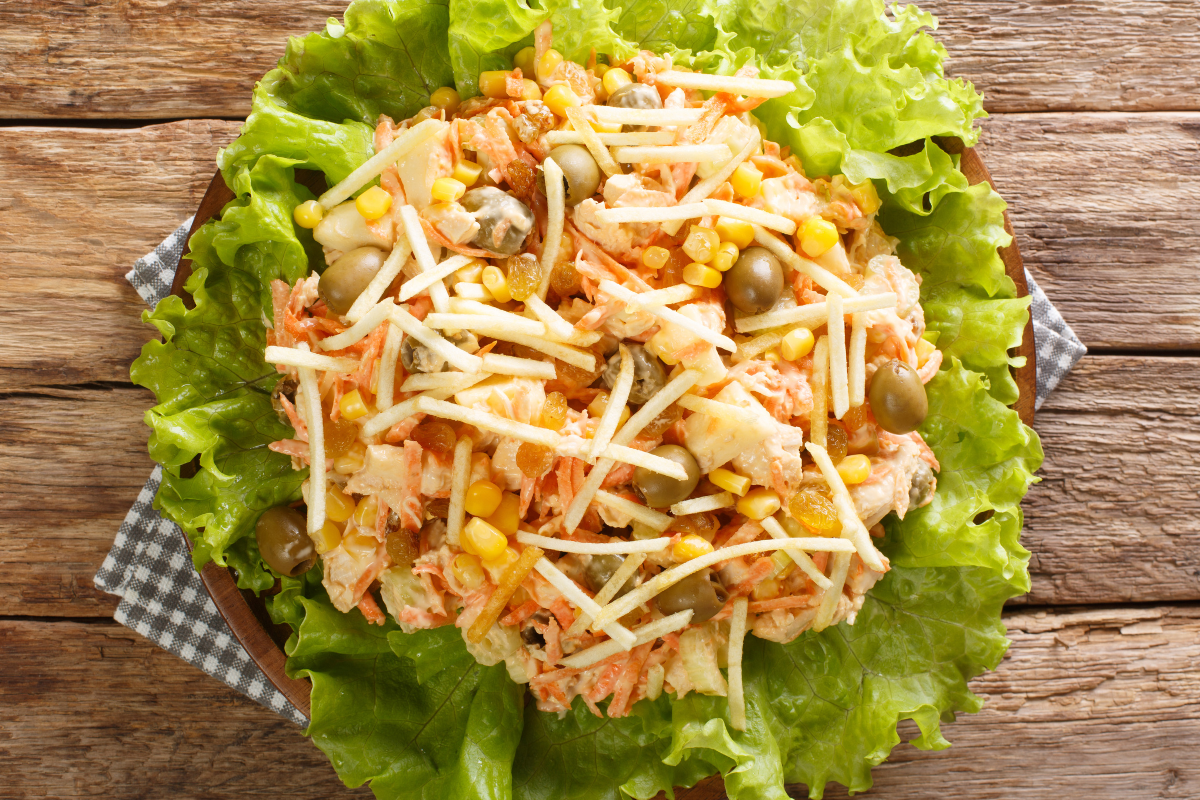 Brazilian-style chicken salad over lettuce and topped with potato sticks