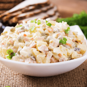 brazilian potato salad in a white bowl with fork