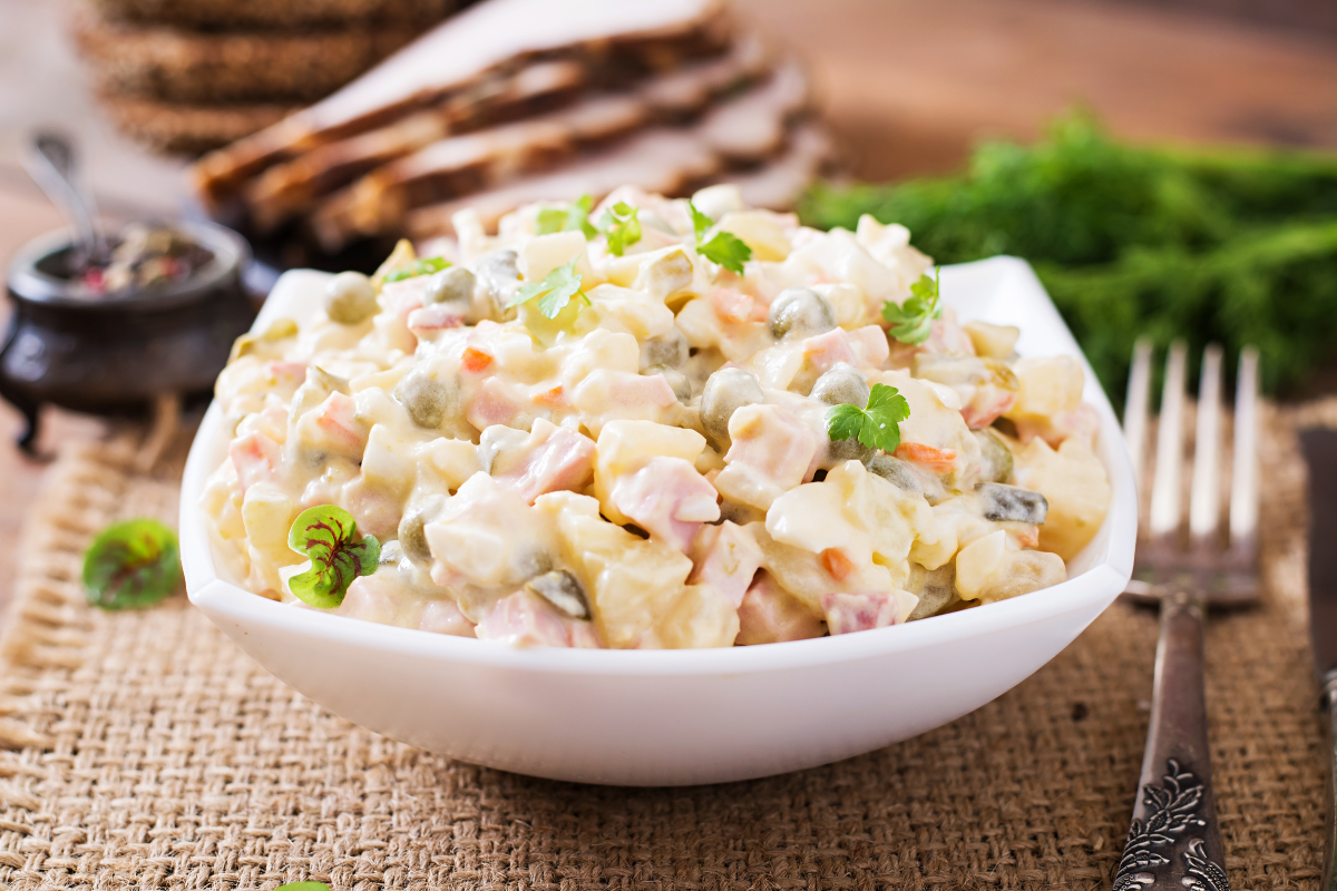 brazilian potato salad in a white bowl with fork