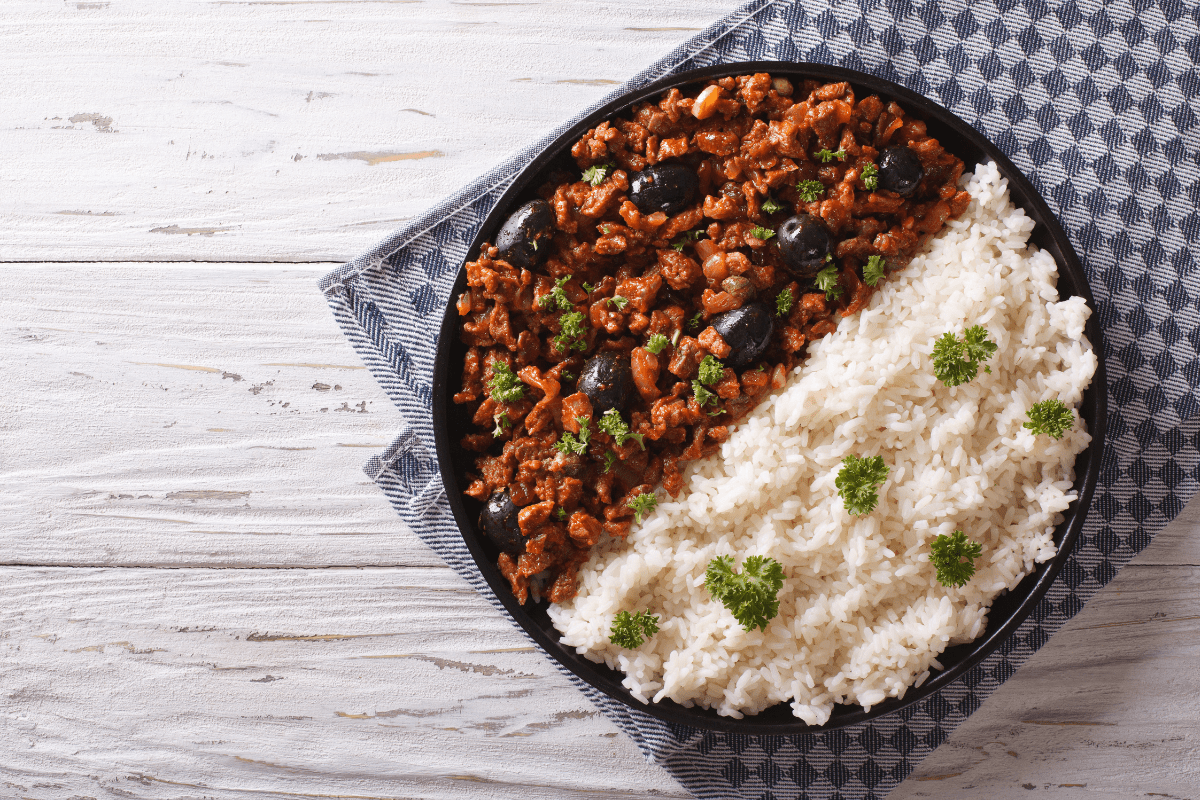 a plate of rice and Brazilian picadillo with olives