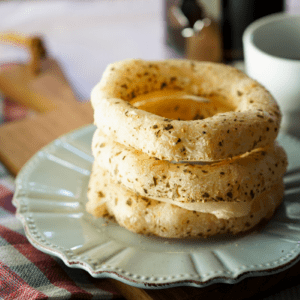 round biscoito de polvilho on a white plate with coffee