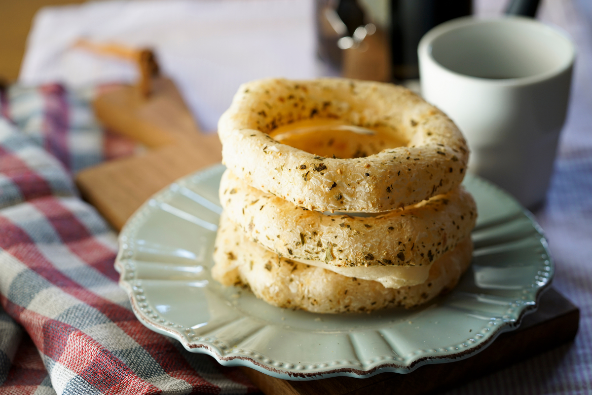 round biscoito de polvilho on a white plate with coffee