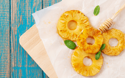 grilled pineapple rings on cutting board
