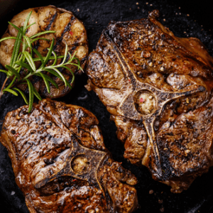 lamb loin chops in skillet with garlic and rosemary