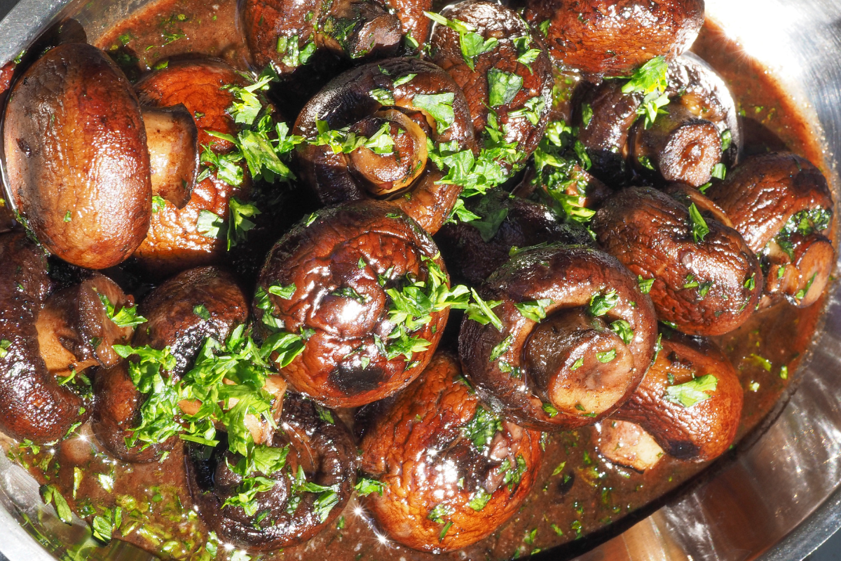 burgundy mushrooms with fresh herbs as garnish