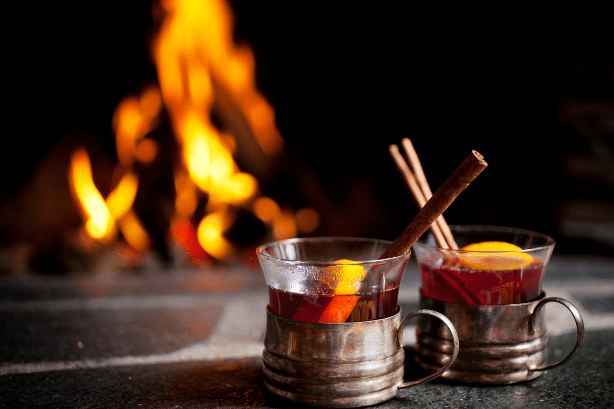 spiced grog in mugs by a fire