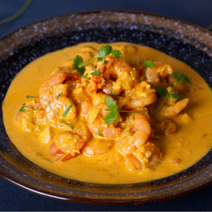 coconut curry shrimp with an earthenware bowl