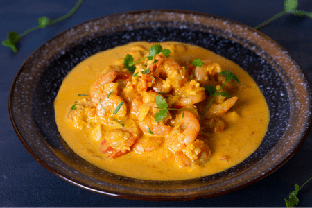 coconut curry shrimp with an earthenware bowl