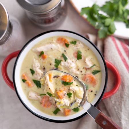 creamy chicken and rice soup in a red pot