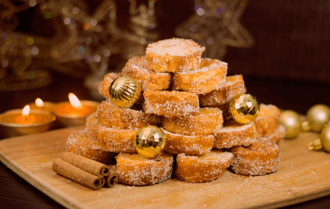 Brazilian rabanada dessert stacked in a pyramid with Christmas ornaments