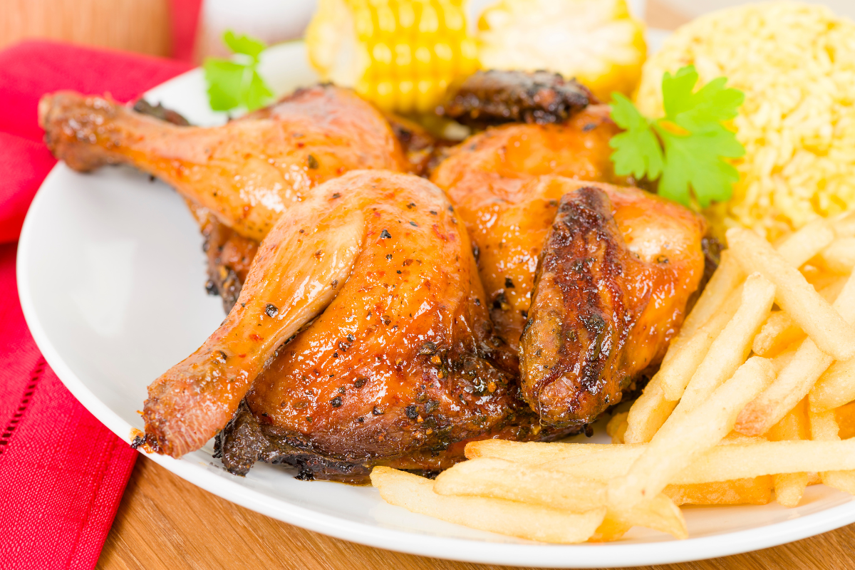 peri peri chicken with french fries, rice, and corn