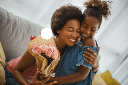 young girl gives roses to her mother for Mother's Day