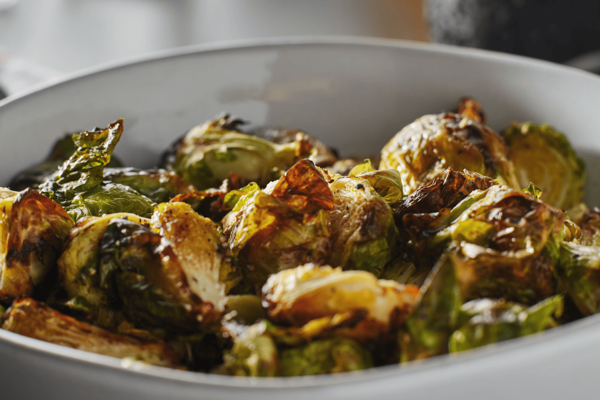 Crispy steakhouse style Brussels sprouts in a white bowl.