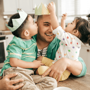 Father playing with two small children