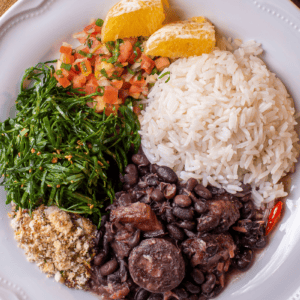 Brazilian rice with feijoada, collards, and orange slices