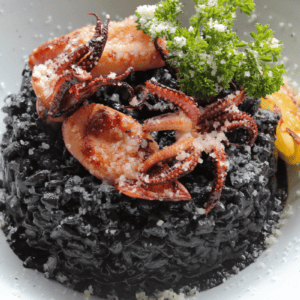 forbidden black rice topped with calamari and shrimp