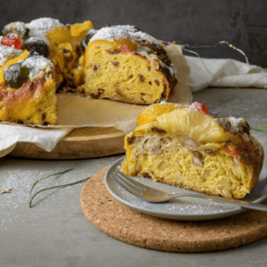 bolo rei with one slice on a plate in front