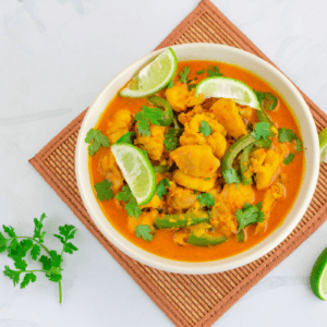 coconut lime chicken with fresh lime and cilantro garnishes