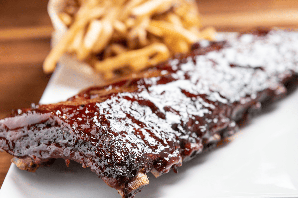 a rack of babyback pork ribs with frires