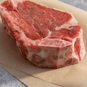 raw cut of bone in filet mignon on butcher paper