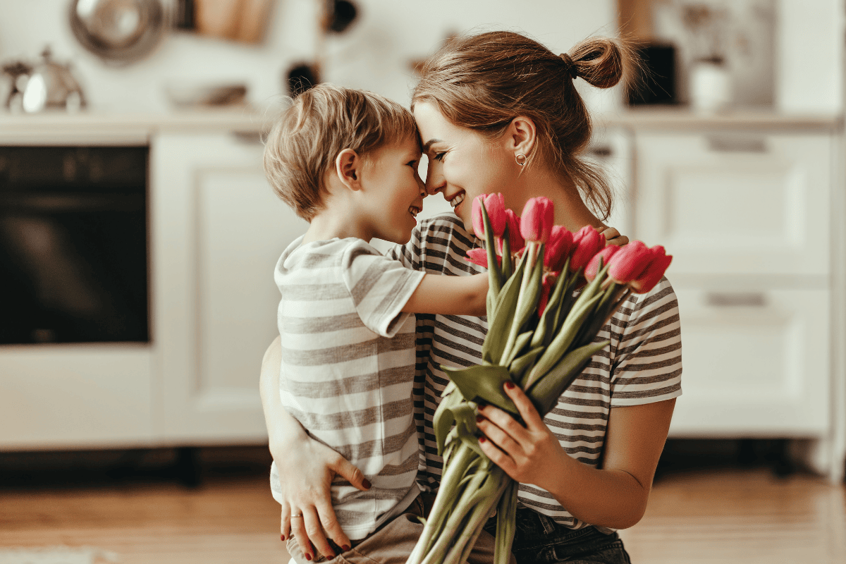 child giving mother tulips to wish her Happy Mother's Day