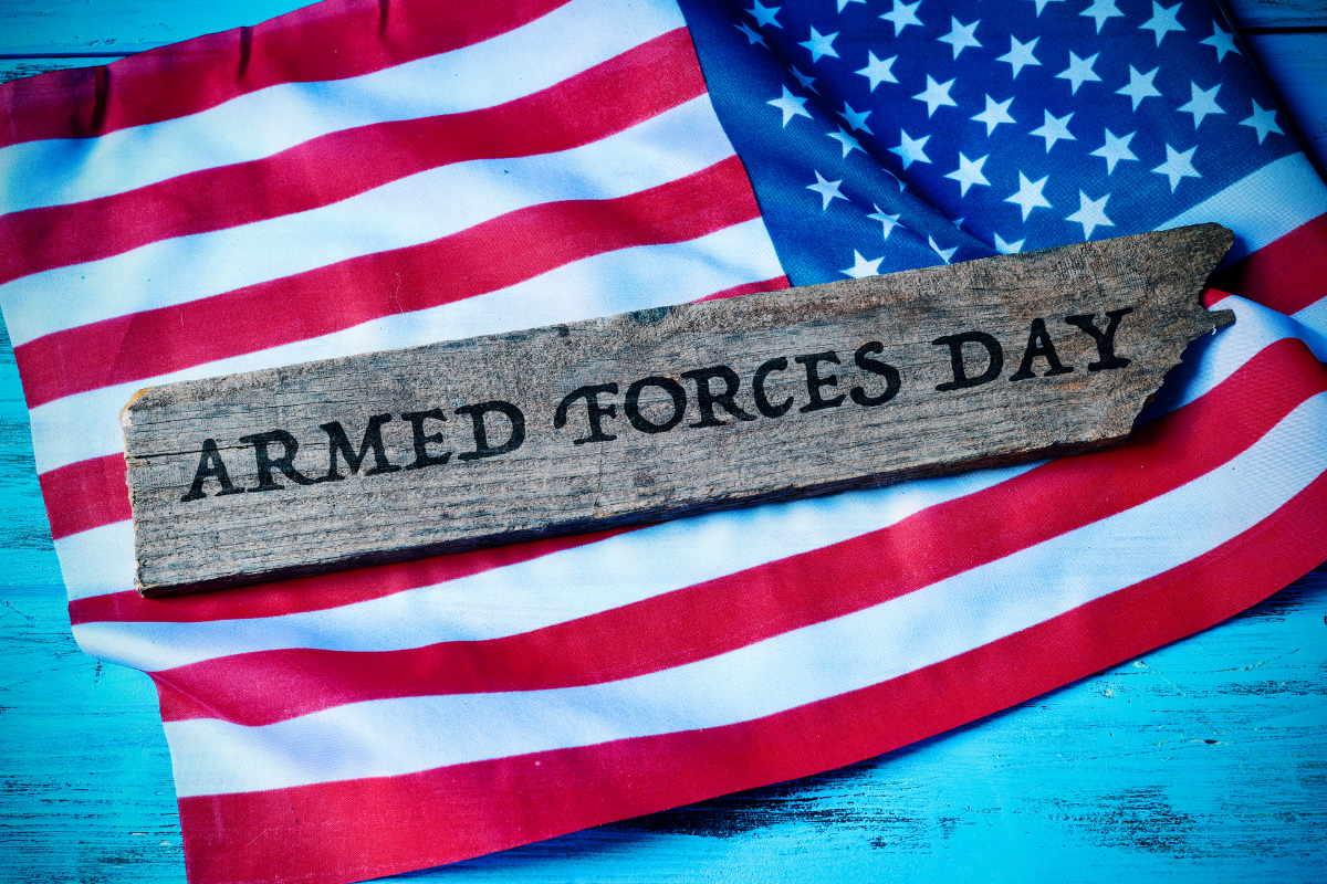 American flag with a wooden plaque reading "Armed Forces Day"